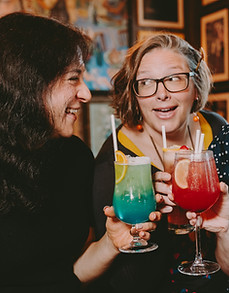 Friends clinking drinks at a venue
